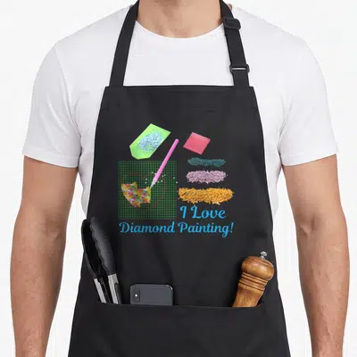Tablier de cuisine noir avec illustration de trame à cœur, pinceau rose et piles de résines colorées en diamond painting.