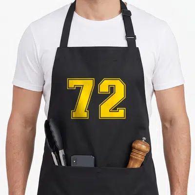 Tablier de cuisine noir avec le grand numéro 72 imprimé en jaune vif au centre du torse.