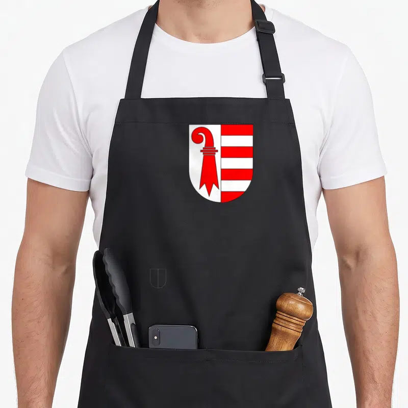 Tablier de cuisine noir avec les armoiries du canton suisse Jura en rouge et blanc.