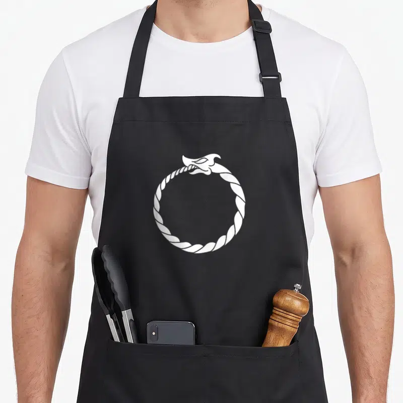Tablier de cuisine noir avec un serpent blanc formant un cercle en se mordant la queue.