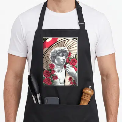 Tablier de cuisine noir avec illustration de David Champignon les roses et un grand champignon rouge en arrière-plan.