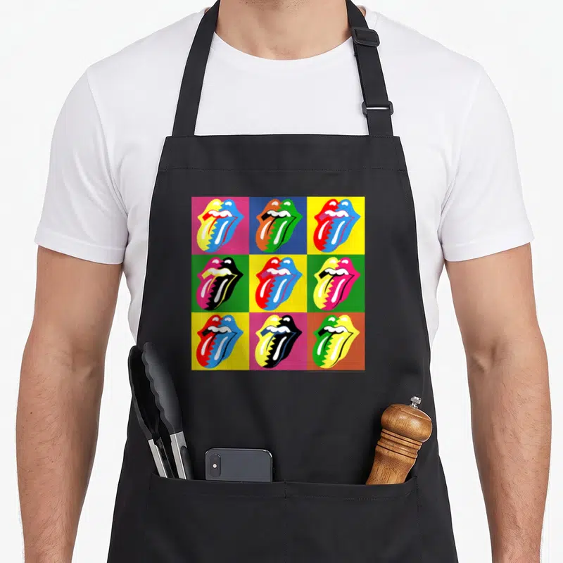 Tablier de cuisine noir avec neuf logos de lèvres et tongue colorés en grille sur fond uni.