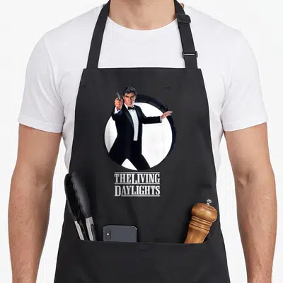 Tablier de cuisine noir avec illustration James Bond 007 et texte The Living Daylights