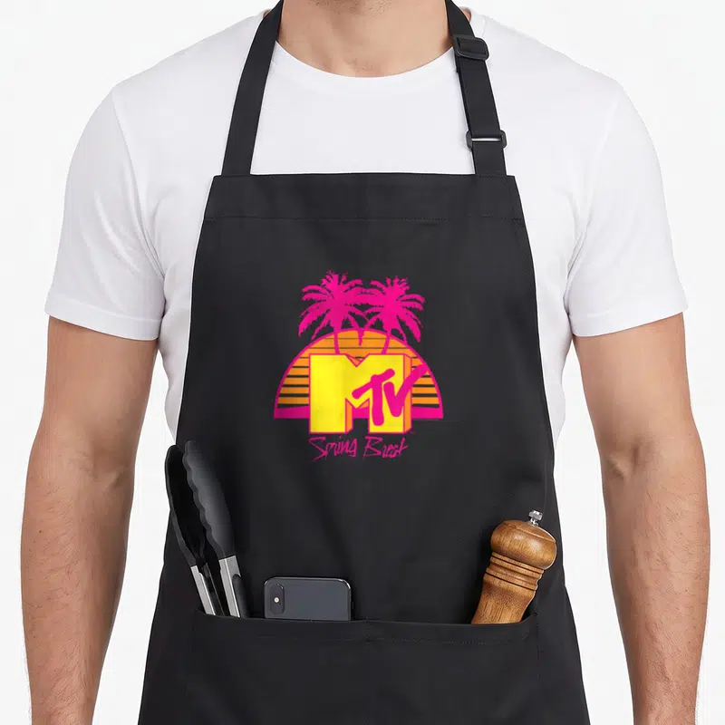 Tablier de cuisine noir avec logo MTV Spring Break, palmiers roses et soleil orange rayé style rétro.