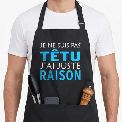Tablier de cuisine noir avec l'inscription Je ne suis pas têtu j'ai juste raison en blanc et bleu.