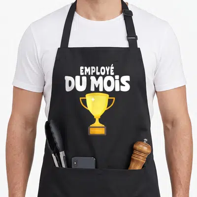 Tablier de cuisine noir avec un trophée doré et l'inscription Employé Du Mois en grosses lettres blanches.