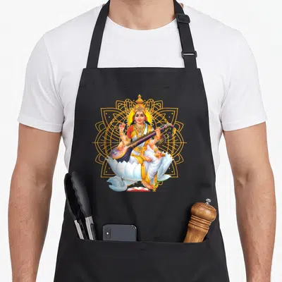 Tablier de cuisine noir avec illustration de Saraswati assise sur un lotus blanc devant une géométrie sacrée dorée.
