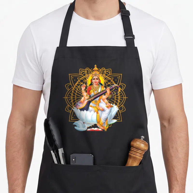 Tablier de cuisine noir avec illustration de Saraswati assise sur un lotus blanc devant une géométrie sacrée dorée.
