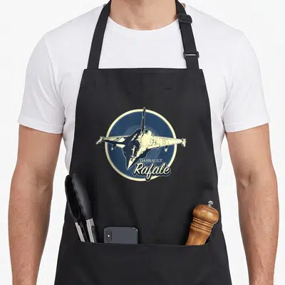 Tablier de cuisine noir avec illustration circulaire d'un Dassault Rafale et texte vintage.