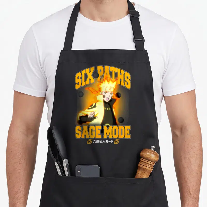 Tablier de cuisine noir avec illustration de Naruto Six Paths Sage Mode et texte orange.