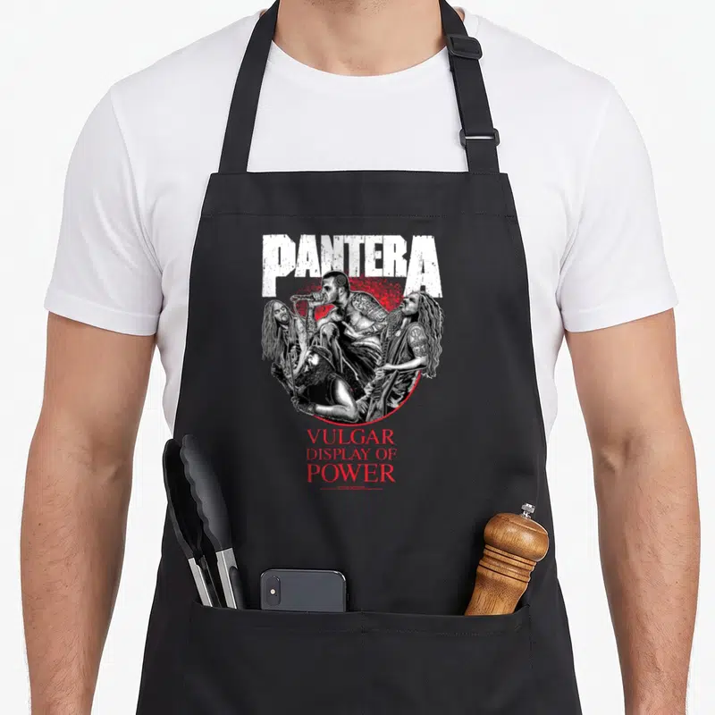 Tablier de cuisine noir avec illustration du groupe Pantera et texte VULGAR DISPLAY OF POWER en rouge.