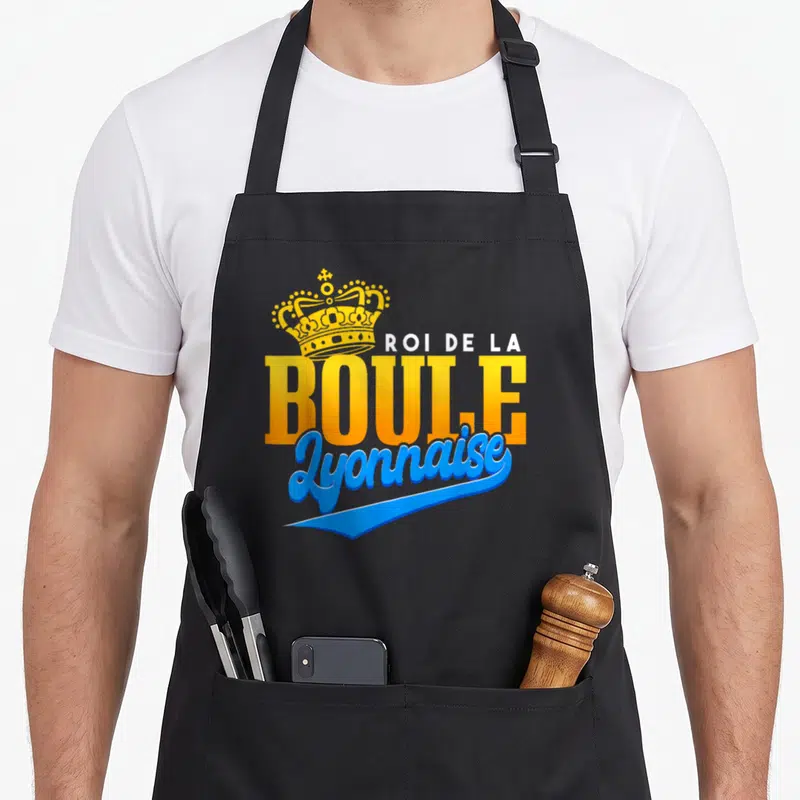Tablier de cuisine noir avec une couronne dorée et l'inscription roi de la boule lyonnaise en orange et bleu.