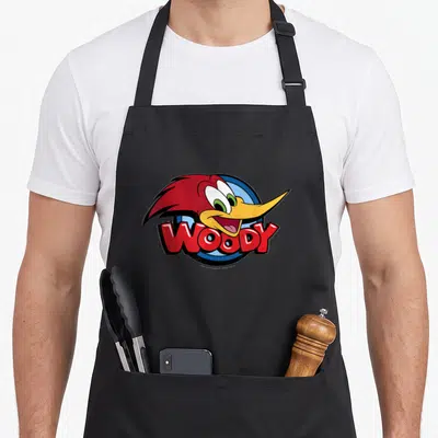 Tablier de cuisine noir avec le logo coloré de Woody Woodpecker Big Face Logo imprimé au centre.