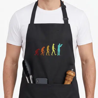 Tablier de cuisine noir avec cinq silhouettes colorées représentant l'évolution d'un barmann en mixologist barman tenant un shaker.