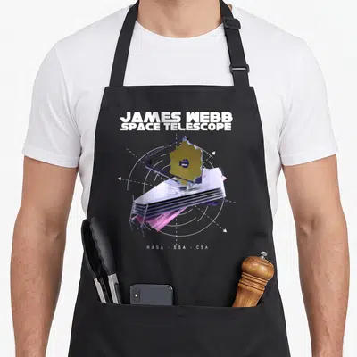 Tablier de cuisine noir avec illustration du télescope spatial James Webb et mentions NASA ESA CSA en bas.