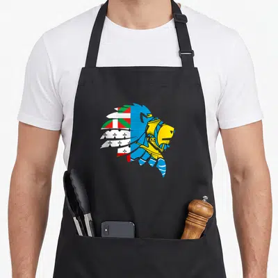 Tablier de cuisine noir avec un lion stylisé aux couleurs de Saint Pierre et Miquelon et une coiffe amérindienne.