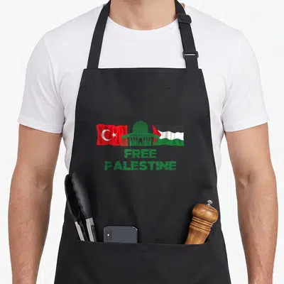 Tablier de cuisine noir avec drapeaux turc et palestinien et le texte Free Palestine en vert.