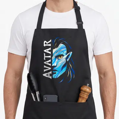 Tablier de cuisine noir avec illustration stylisée du visage de Jake Sully et le mot AVATAR en blanc.