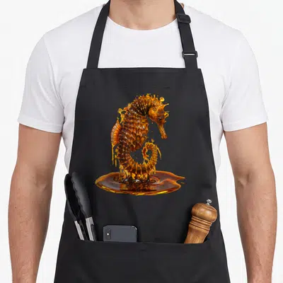 Tablier de cuisine noir avec un hippocampe formé par du miel doré gorgé de détails.