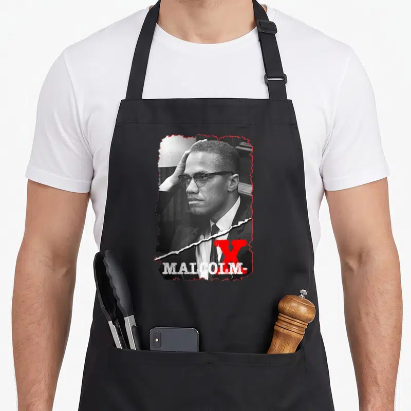 Tablier de cuisine noir avec portrait stylisé de Malcolm X et lettre V rouge