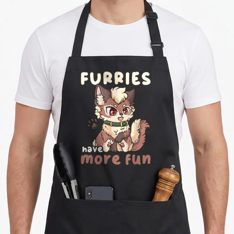 Tablier de cuisine noir avec illustration d'un petit animal anthropomorphe et du texte Furries have more fun imprimé en lettres arrondies.