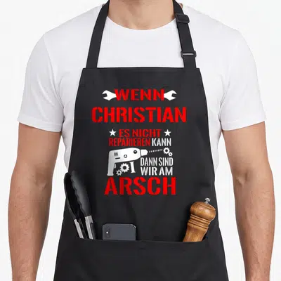 Tablier de cuisine noir avec inscription rouge et blanche sur le bricolage et une illustration de perceuse électrique.