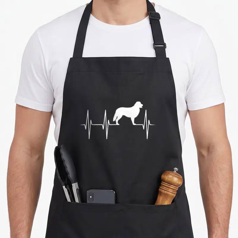 Tablier de cuisine noir avec silhouette blanche de Bouvier Bernois sur fond de rythme cardiaque stylisé