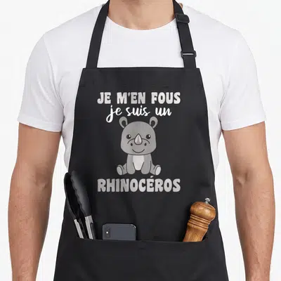 Tablier de cuisine noir avec un dessin de rhinocéros gris et le texte Je m'en fous je suis un rhinocéros