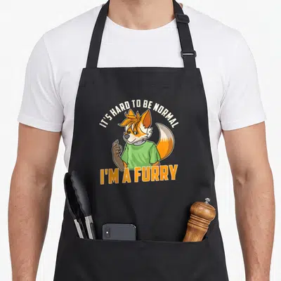 Tablier de cuisine noir avec fox anthropomorphe en « t-shirt vert » et texte orange.