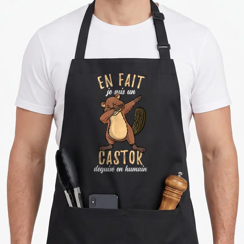 Tablier de cuisine noir avec un castor marron effectuant un mouvement dab et du texte humoristique imprimé.