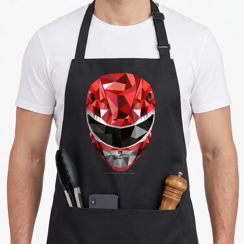 Tablier de cuisine noir avec casque Power Rangers rouge style polygonal géométrique aux facettes vives.