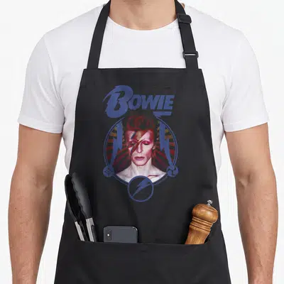 Tablier de cuisine noir avec portrait Bowie Foudre Bleu et lettrage violet stylisé.
