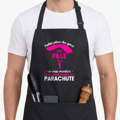 Tablier de cuisine noir avec cette fille va vous montrer comment sauter en parachute et une silhouette rose sous voilier.