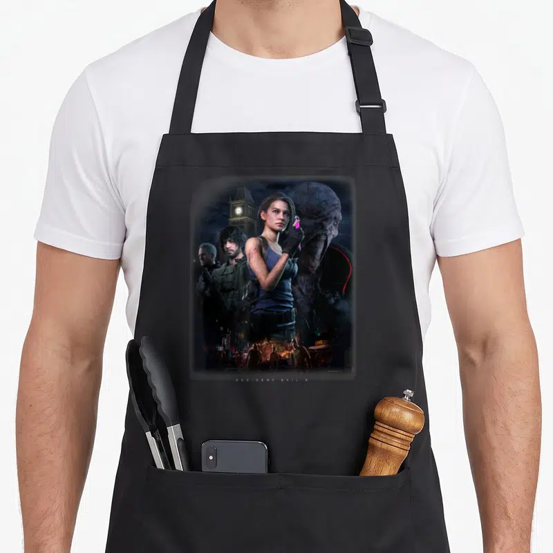 Tablier de cuisine noir avec une illustration de Jill Valentine tenant une seringue face au Tyrant dans une ville dévastée.