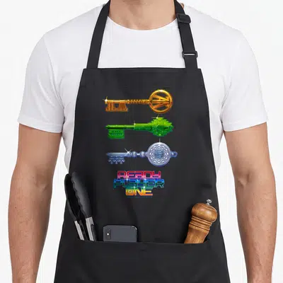 Tablier de cuisine noir avec trois clés stylisées dorée verte et argentée sous un logoReady Player One multicolore