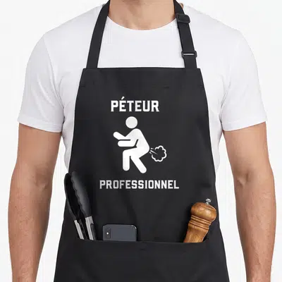 Tablier de cuisine noir avec une silhouette blanche assise et le texte PÉTEUR PROFESSIONNEL imprimé en haut et en bas.