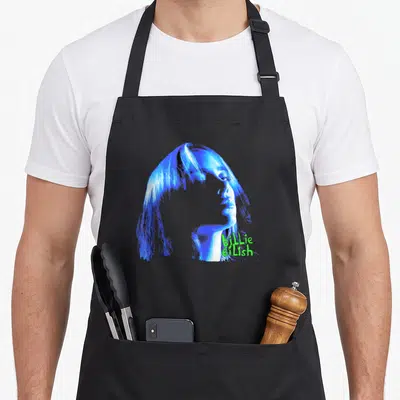 Tablier de cuisine noir avec portrait stylisé bleu de Billie Eilish et son nom écrit en vert fluo sur le côté.