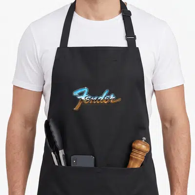 Tablier de cuisine noir avec le logo Fender Chrome Logo en script bicolore bleu et bronze au centre.