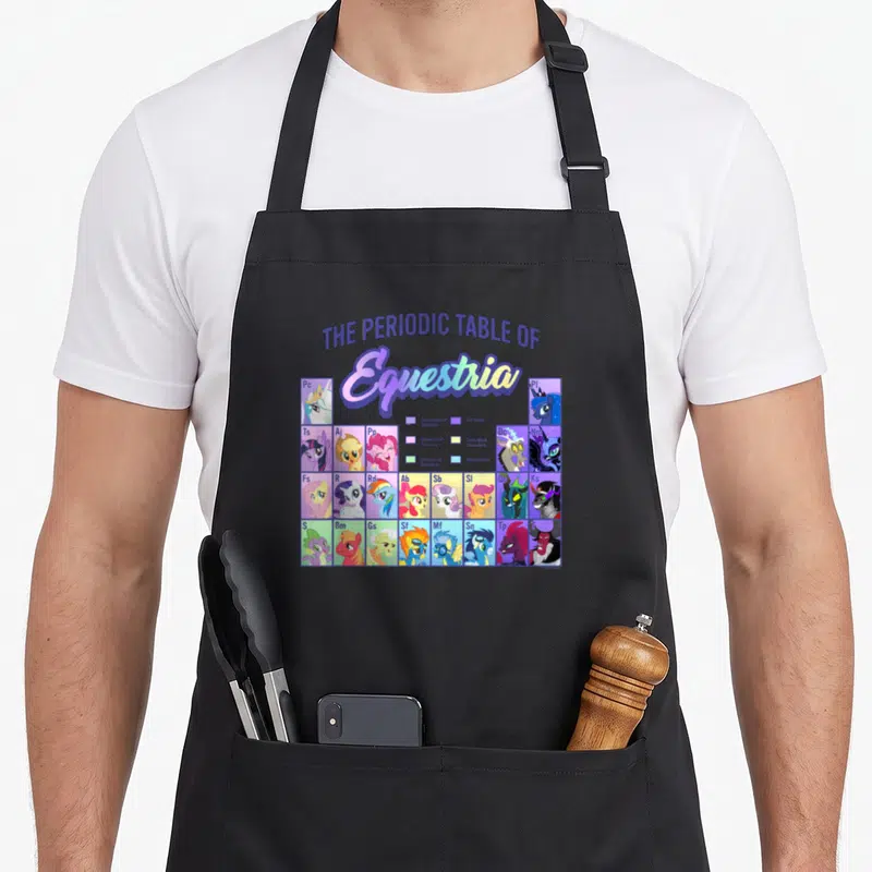 Tablier de cuisine noir avec une illustration colorée représentant la table périodique des personnages d'Equestria sous forme de grille scientifique.