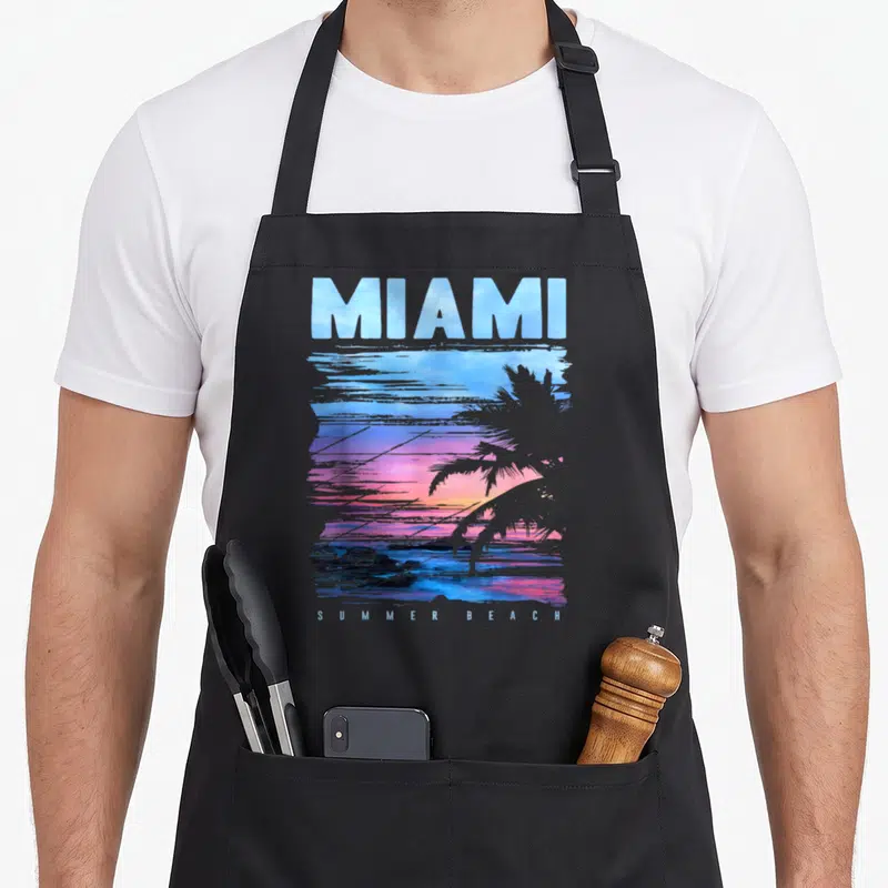Tablier de cuisine noir avec illustration sunset Miami, palmier et texte Summer Beach en bas.