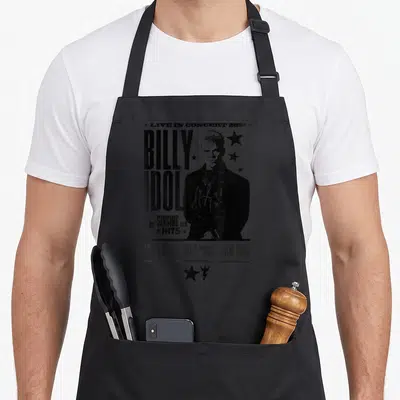 Tablier de cuisine noir avec illustration monochrome de Billy Idol et texte Live in Concert 2021 entouré d'étoiles.