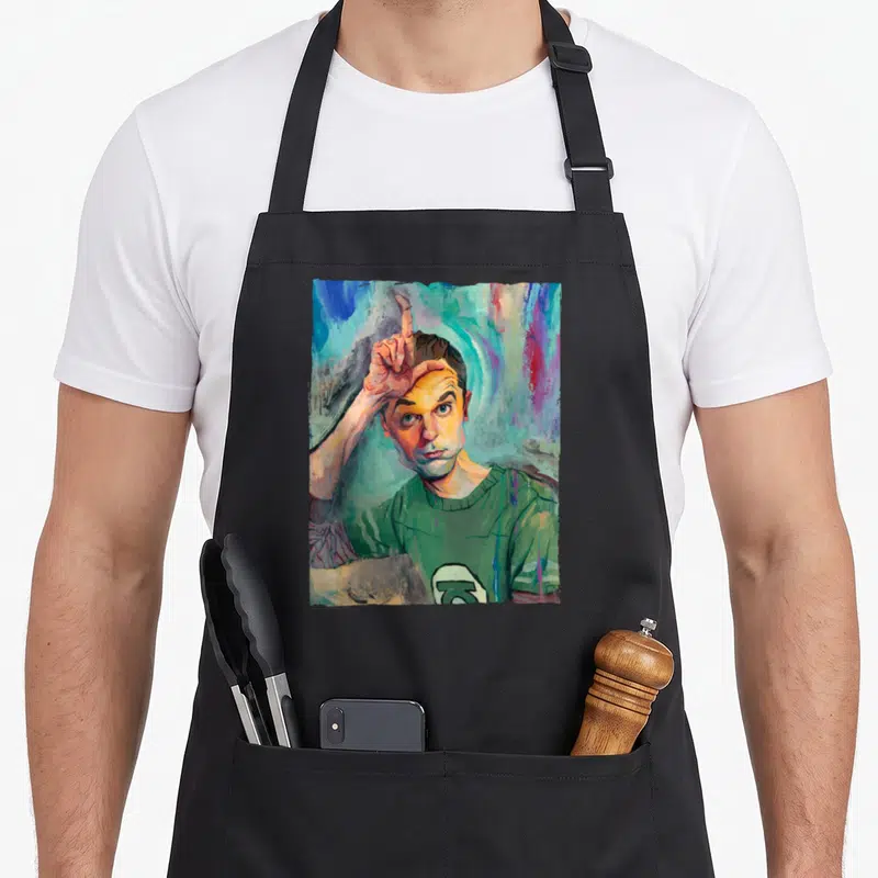 Tablier de cuisine noir avec portrait peint de Sheldon le doigt levé sur fond coloré abstrait
