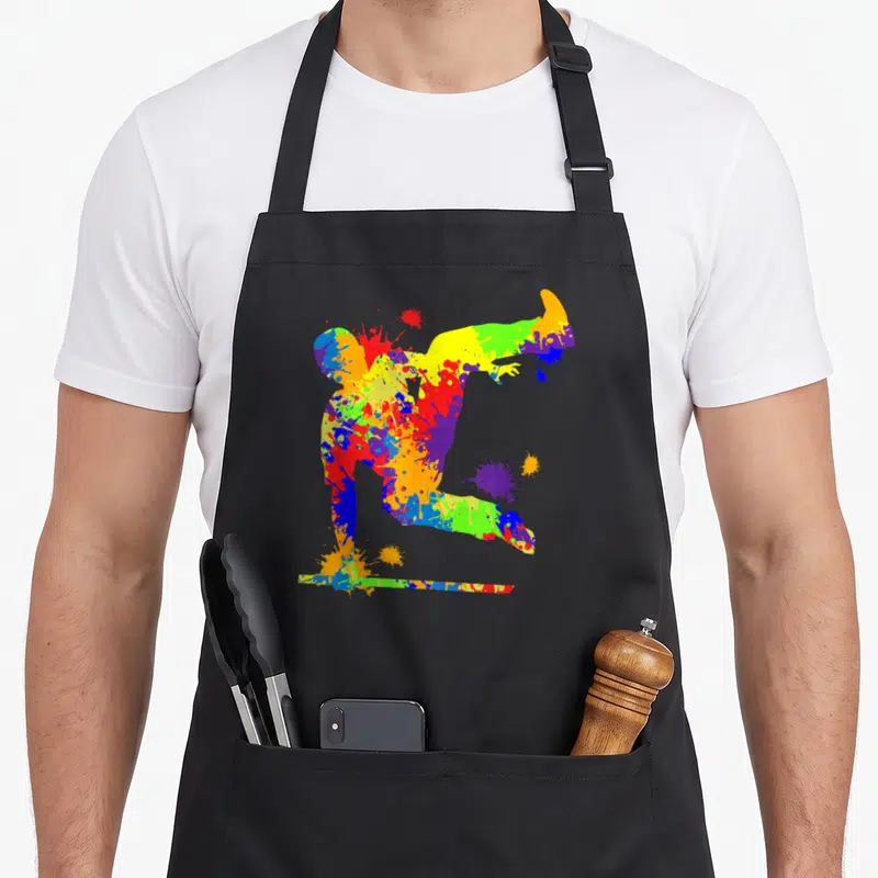 Tablier de cuisine noir avec silhouette de parkour aux couleurs vives et éclats de peinture artistique.