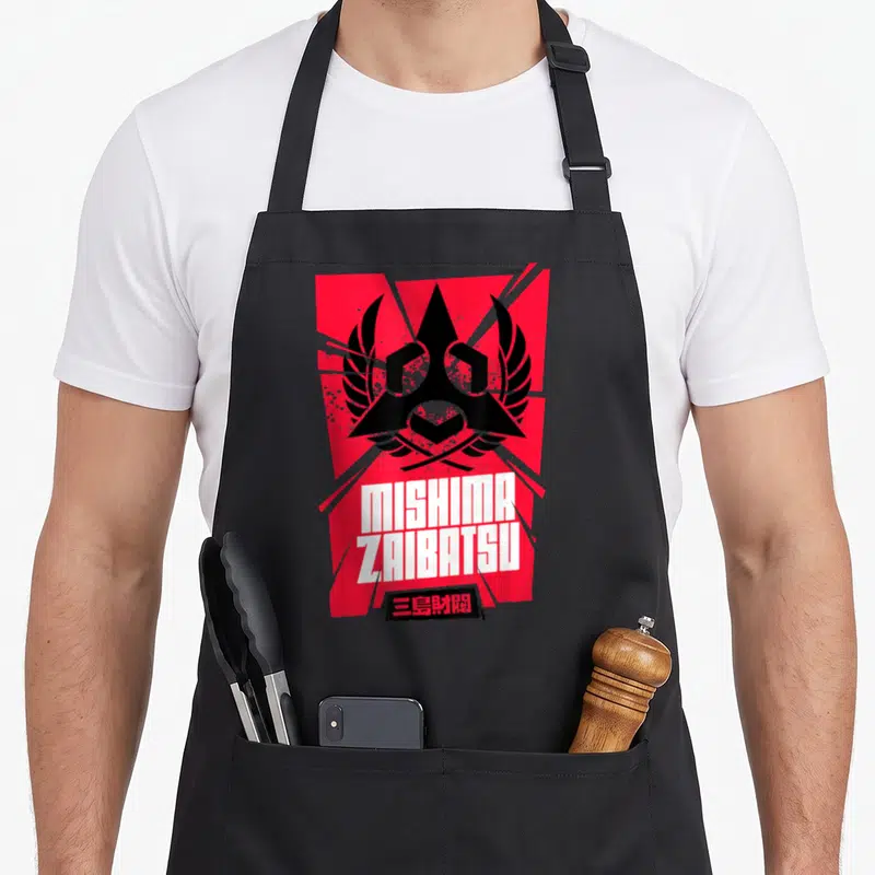 Tablier de cuisine noir avec l'emblème Mishima Zaibatsu rouge, noir et texte blanc.