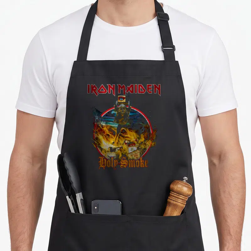 Tablier de cuisine noir avec le logo Iron Maiden et l'illustration Holy Smoke Circle au centre.