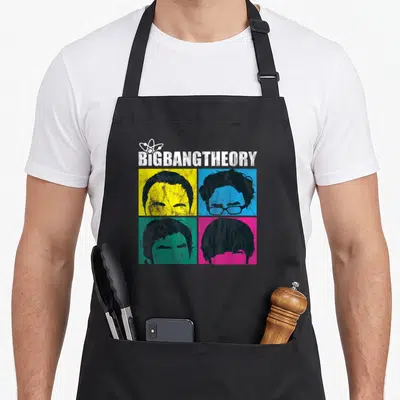 Tablier de cuisine noir avec motif pop art représentant les têtes des personnages de la série en quatre cases colorées.