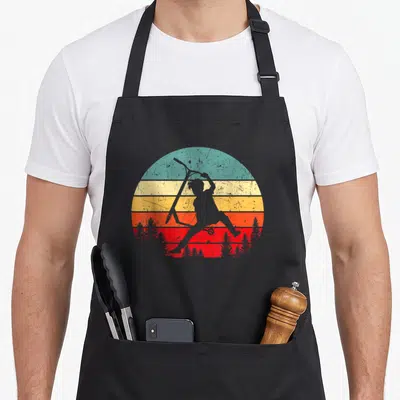 Tablier de cuisine noir avec silhouette enfant trottinette devant fond soleil rayé vintage orange jaune et bleu turquoise