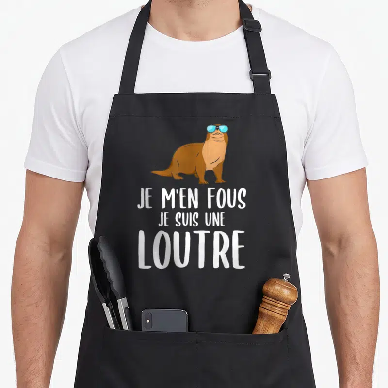 Tablier de cuisine noir avec illustration loutre lunettes bleues et texte blanc Je m'en fous je suis une loutre.