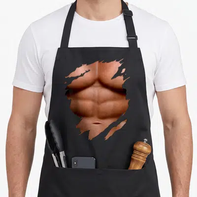 Tablier de cuisine noir avec illustration d'un torse musclé aux six pack abs et huge muscles beach bodybuilder au centre.