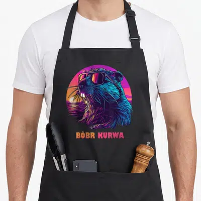 Tablier de cuisine noir avec illustration colorée d'un castor portant des lunettes de soleil et le texte Bóbr Kurwa en bas.